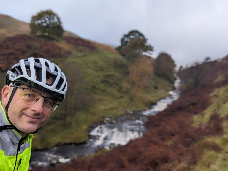 Why would I do this? It isn't always the weather. A picture of me, on a grotty day, in the foreground of a beautiful Welsh waterfall.
